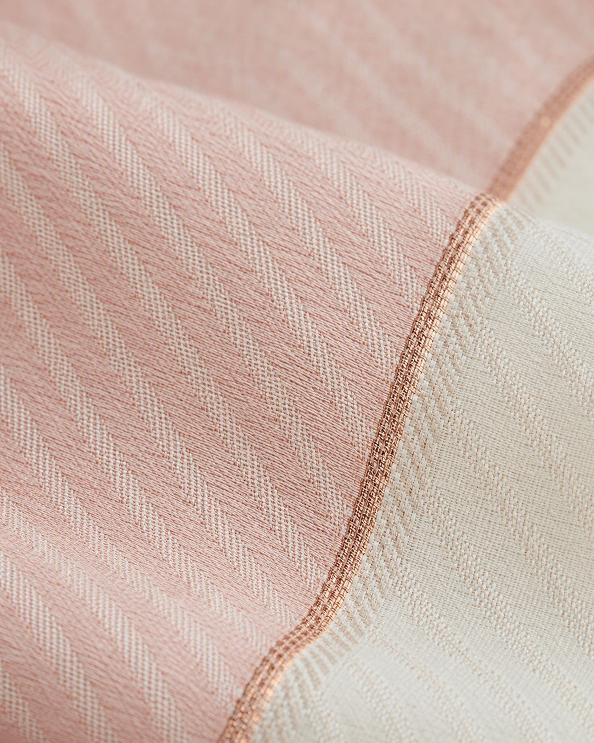 Close view of the diagonal woven pattern on the blush and ivory saree body